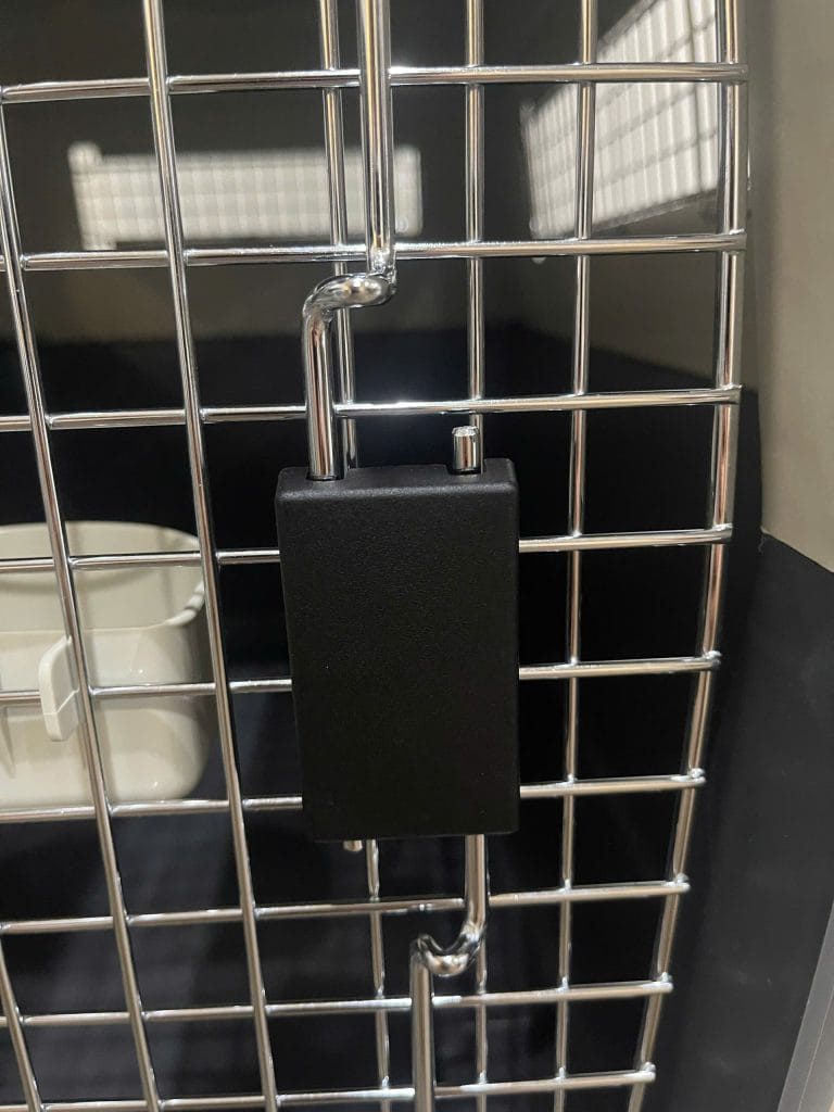 Metal door of an IATA pet crate with its locking mechanism