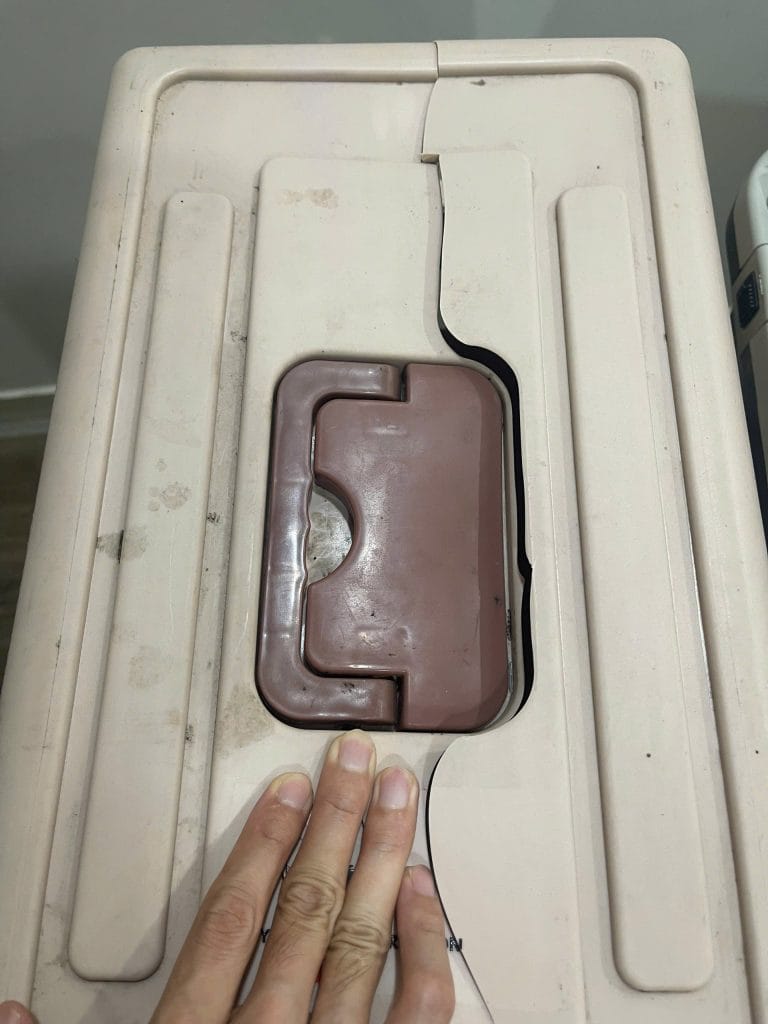 Standard plastic pet crate with a caved-in roof