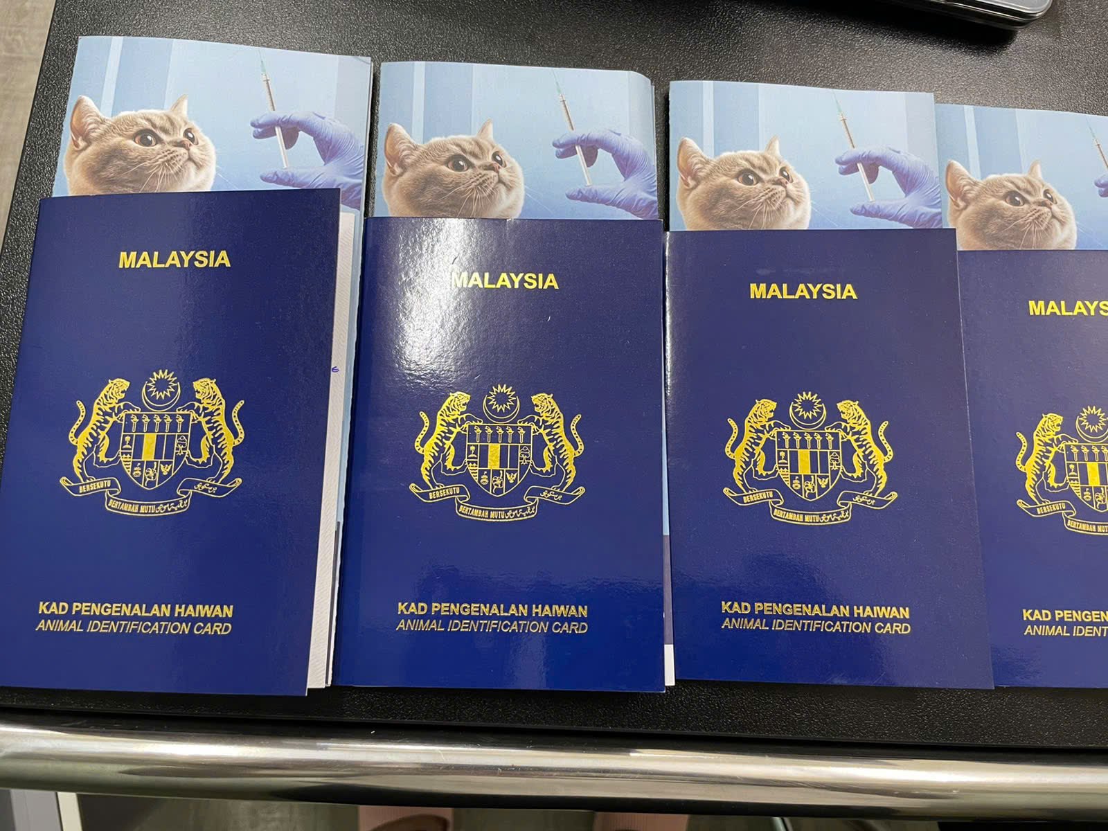 Four Malaysian Pet Passport booklets, the Animal Identification Card issued by DVS Malaysia