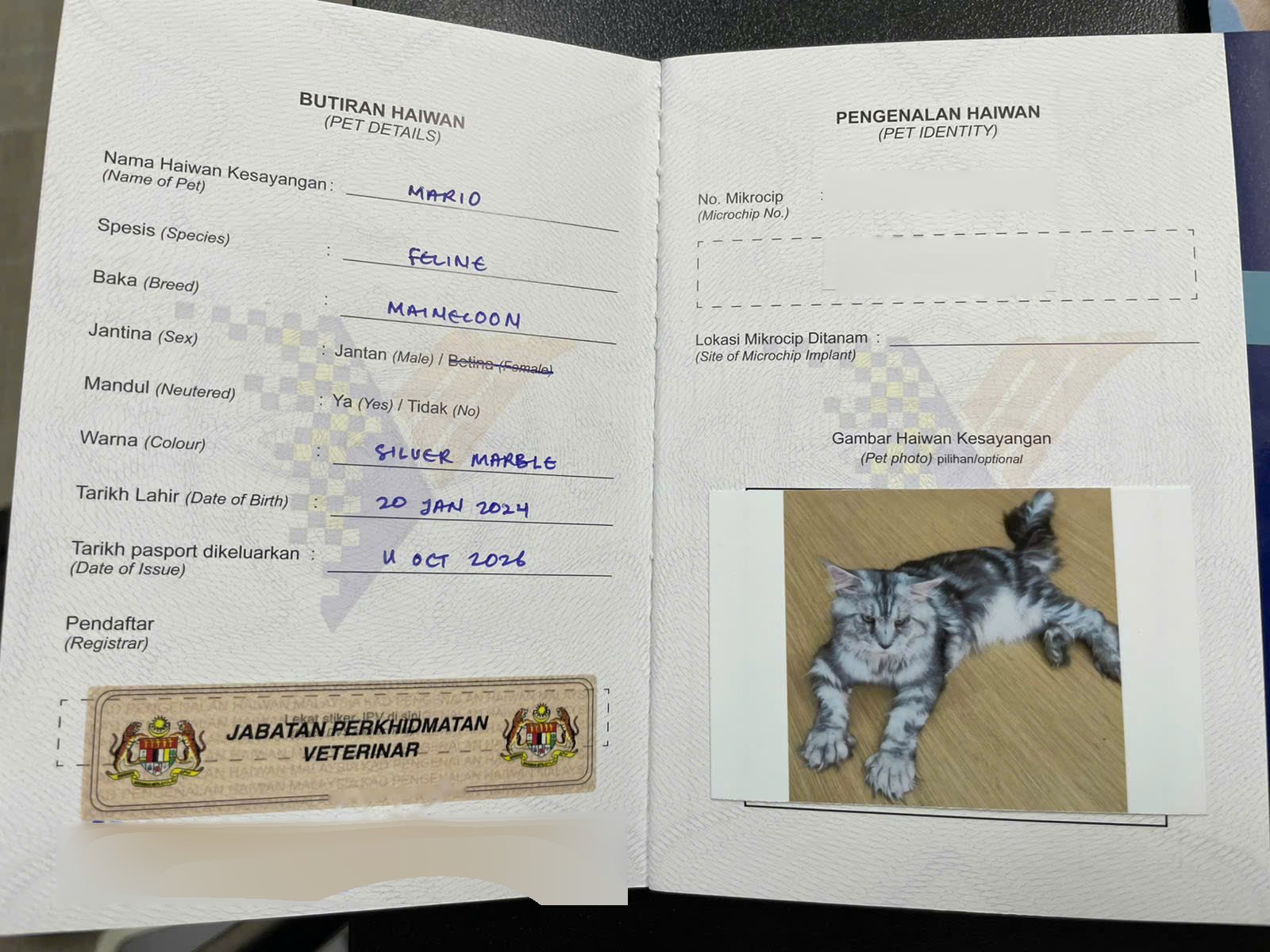 Pet details and microchip identity pages of a Malaysian Pet Passport, with the DVS registrar stamp